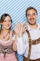 Free photo bavarian couple smiling at camera