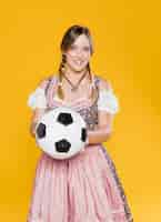 Free photo bavarian young woman holding football