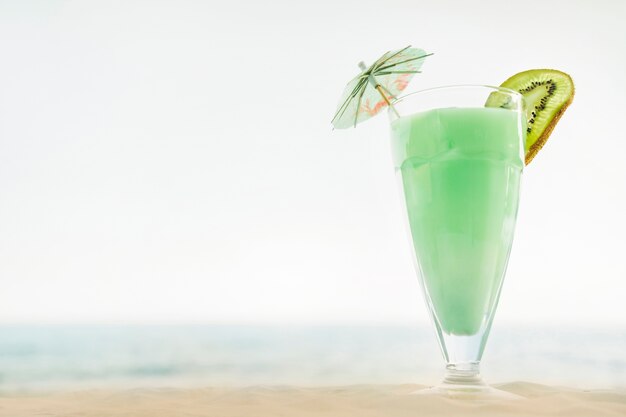 Beach background with kiwi cocktail