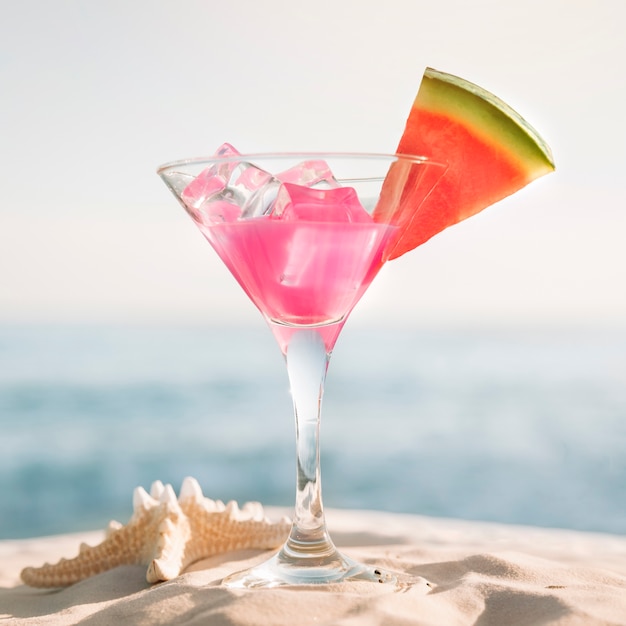 Beach background with watermelon and cocktail