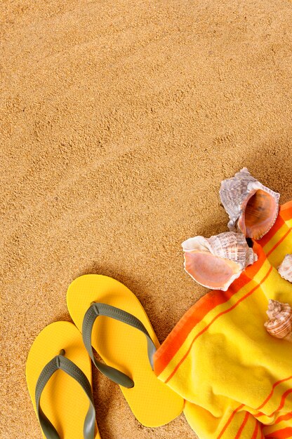 Beach background with yellow towel 