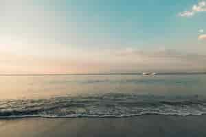 Free photo beach and calm ocean in sunset lights