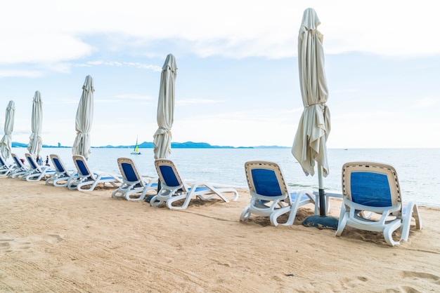 Free photo beach chair, palm and tropical beach at pattaya in thailand