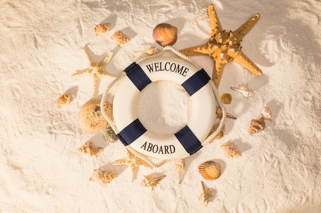 Beach composition with lifebuoy on sand