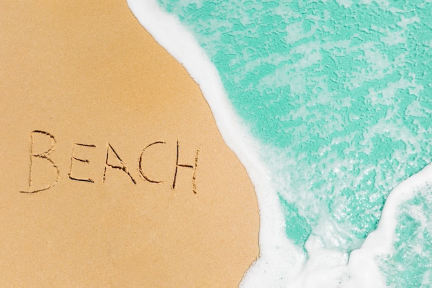 Free Photo beach concept with beach written in sand