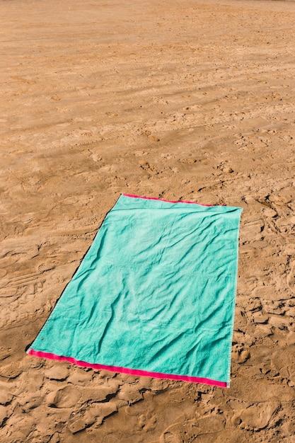 Beach concept with green towel