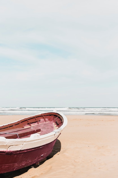 Beach concept with red boat