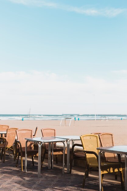 Free Photo beach concept with tables and chairs