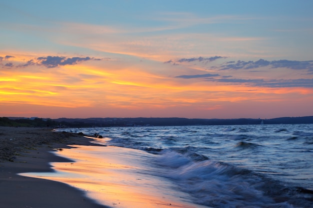 Free Photo beach at sunset with clouds