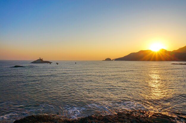 Beach at sunset with mountains