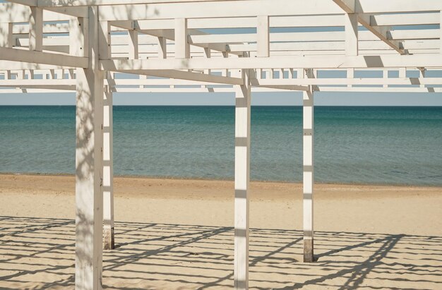 Beach wooden awnings on an empty sandy beach selective focus Vacation at the seaside resort