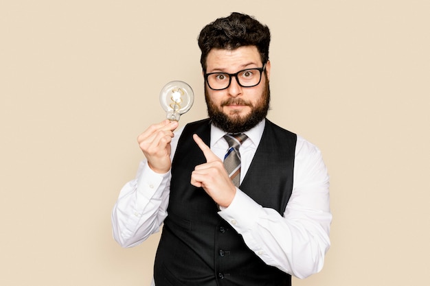 Free Photo bearded businessman holding a light bulb for innovation campaign