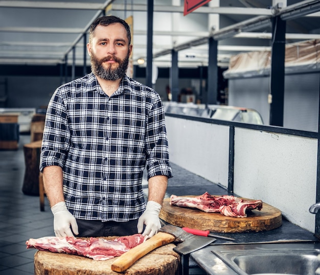 Free Photo bearded butcher working in butchers shop