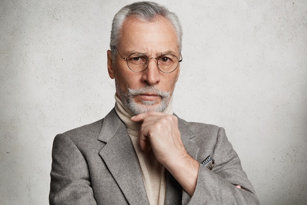 Free Photo bearded grey-haired elderly man wearing formal suit