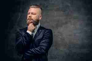 Free photo bearded hipster male in purple suit isolated  on grey vignette background.