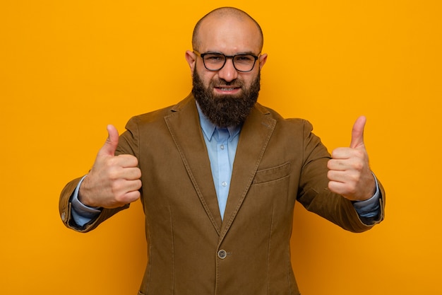 Free photo bearded man in brown suit wearing glasses looking happy and cheerful smiling broadly showing thumbs up