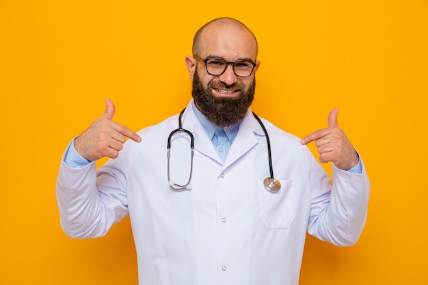 Bearded man doctor in white coat with stethoscope around neck wearing glasses looking smiling confident pointing at himself