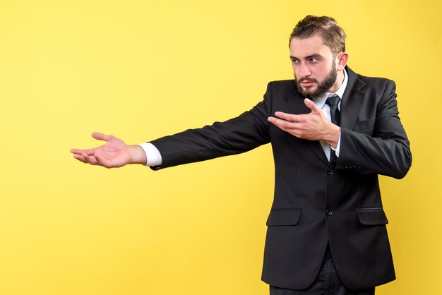 Bearded man pointing something on isolated yellow