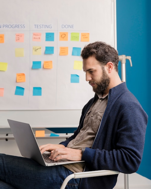 Bearded man working on laptop