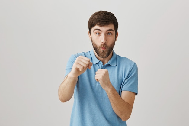 Bearded portrait of a young guy with blue Tshirt