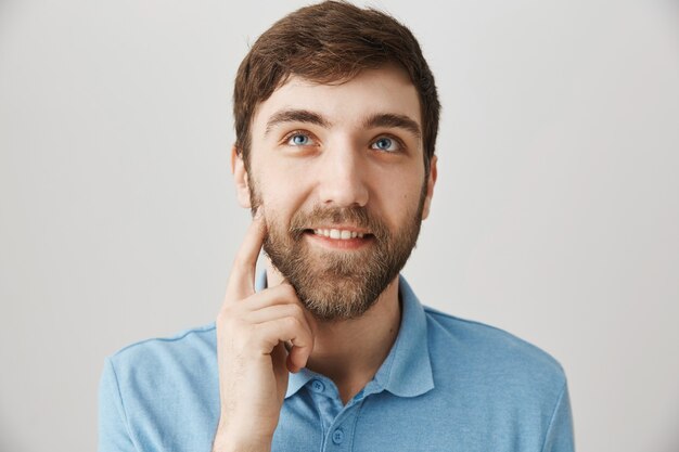 Bearded portrait of a young guy with blue Tshirt