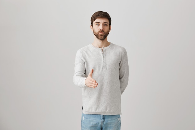 Bearded portrait of a young guy with a white blouse