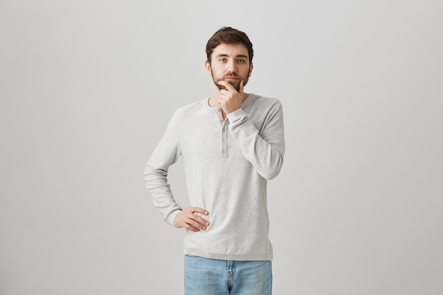 Bearded portrait of a young guy with a white blouse