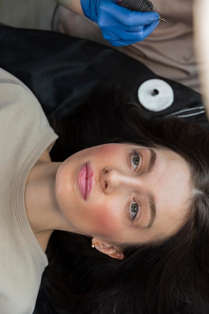 Free Photo beautician doing an eyebrow treatment for her female client