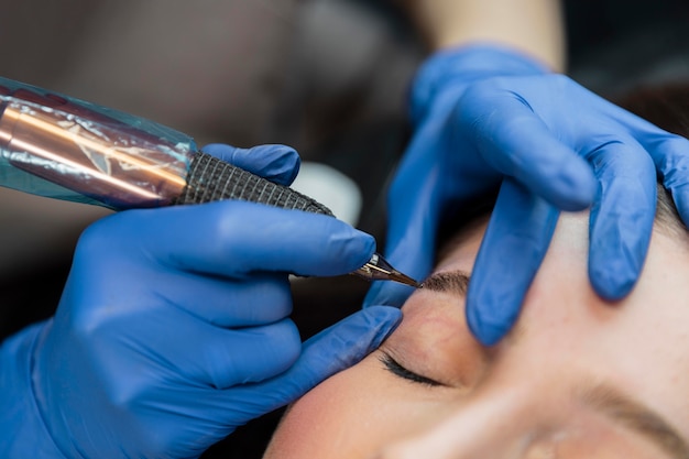 Beautician doing an eyebrow treatment for her female client