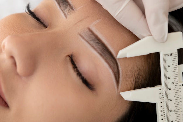 Beautician working on a client's eyebrows