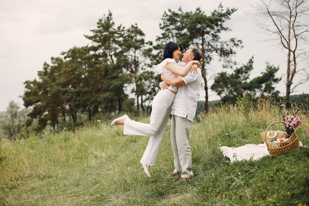 Beautiful adult couple spends time in a summer field