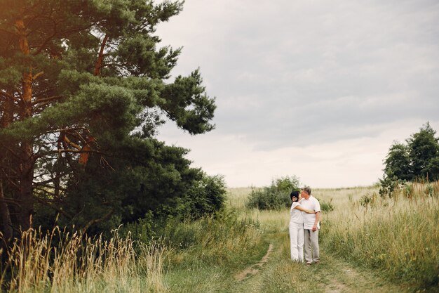 Beautiful adult couple spends time in a summer field