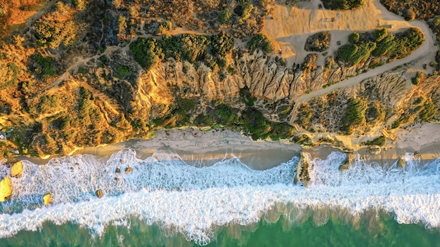 Beautiful aerial photography of the shoreline of the sea with amazing waves on a sunny day