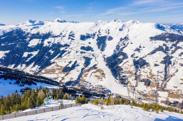 Free photo beautiful aerial view of a ski resort and a village in a mountains landscape, in the alps