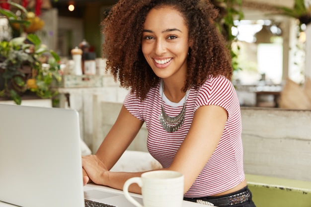 Beautiful African-American woman in cafe