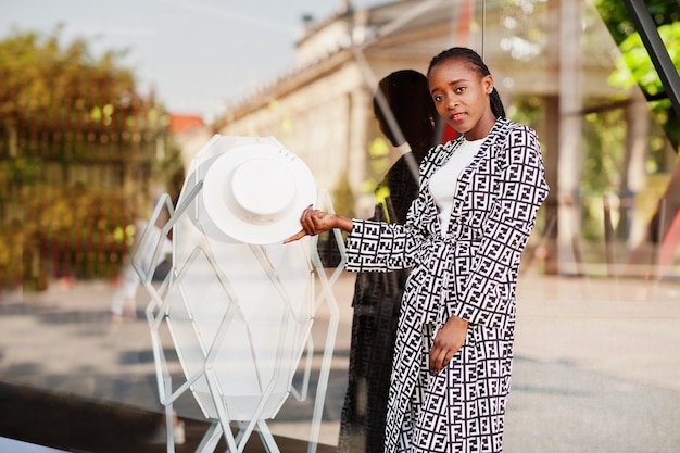 Beautiful african american woman natural makeup wear fashion clothes casual black and white dress code office style total blouse and pants suit and hat