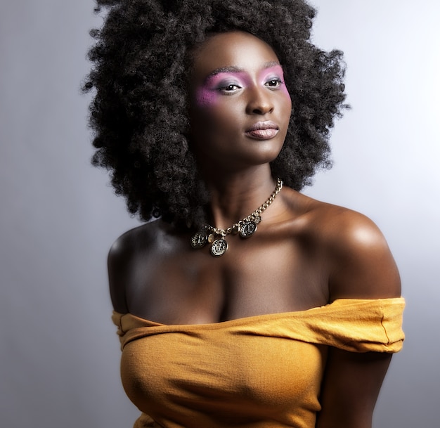 Beautiful African Woman with big curly  Afro and flowers in her hair