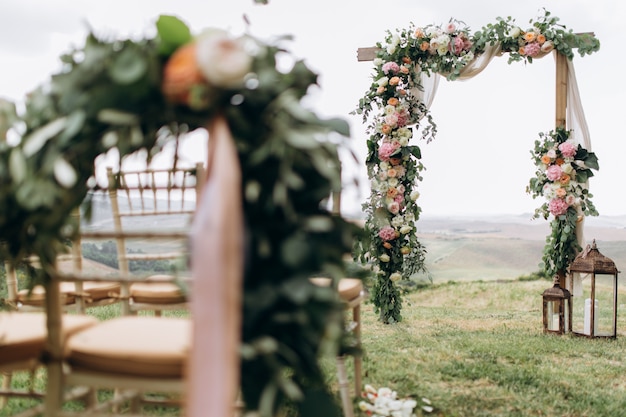 Beautiful arch decorated with eucalyptus and different fresh flowers