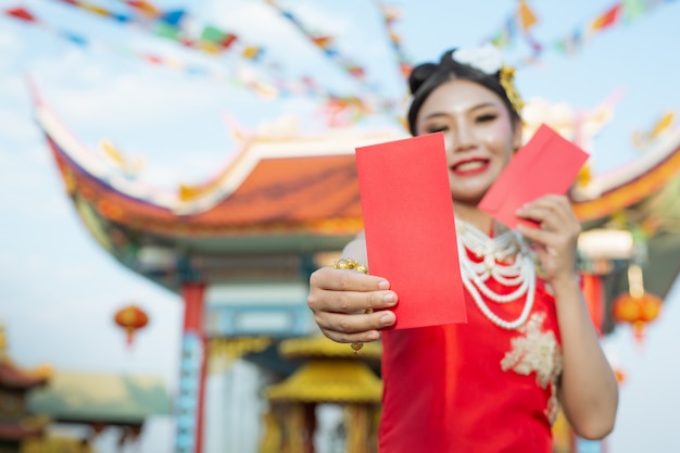 Free photo a beautiful asian girl wearing a red dress