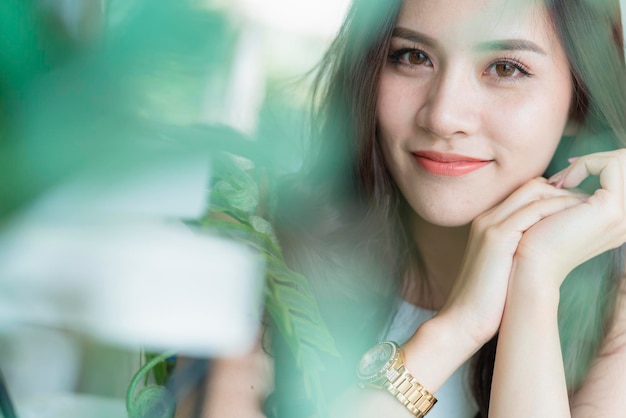 Beautiful asian woman nice smile and healthy skin with green leaf tree portrait