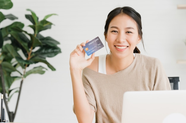 Beautiful Asian woman using computer or laptop buying online shopping