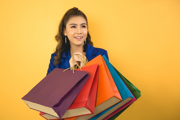 Beautiful asian woman with shopping bag and credit card in hand