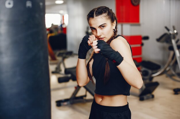 A beautiful and athletic sportswear girl training in the gym