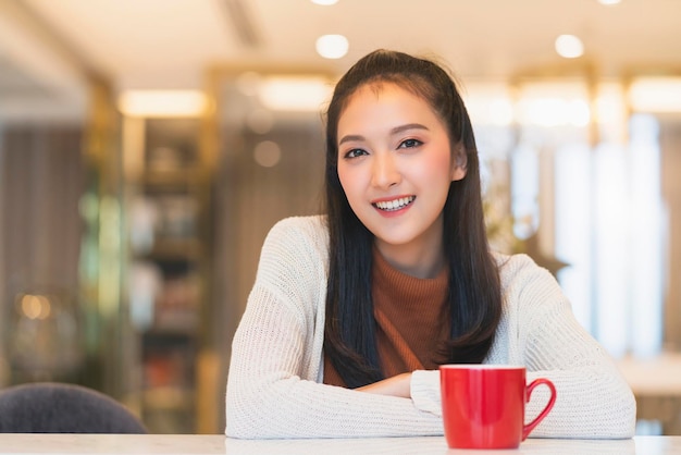 Free photo beautiful attractive asian female freshness smile cheerful morning working with laptop coffee work from home with happiness enjoy garden view asian young woman with window light garden background