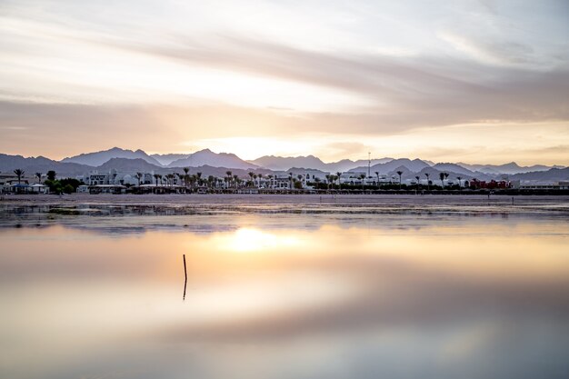 Beautiful background landscape at sunset by the sea. With lone figures in the distance.