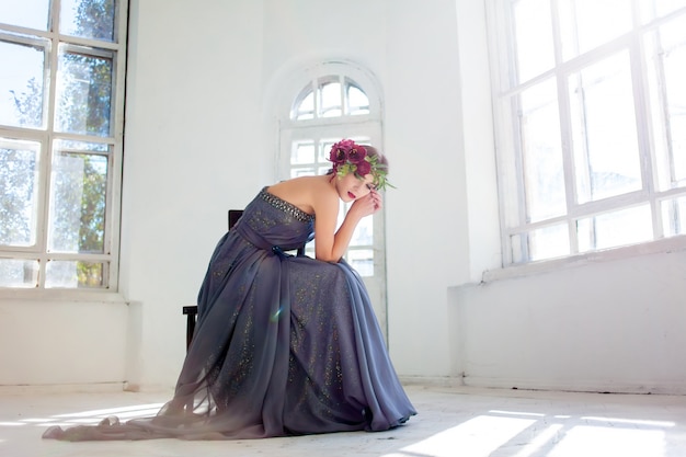 Free photo the beautiful ballerina sitting in long gray dress