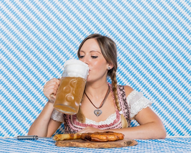 Beautiful bavarian girl drinking beer