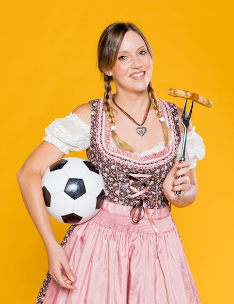 Free photo beautiful bavarian woman with football