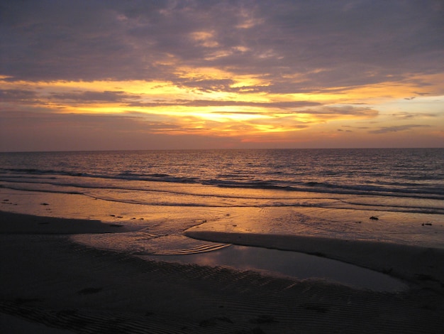 Beautiful beach and the ocean under the colorful sky at sunset