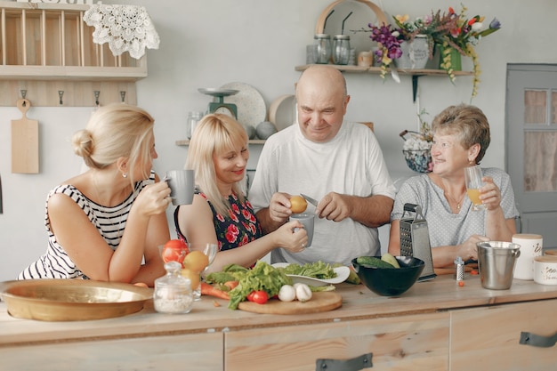 Beautiful big family prepare food in a kitchen